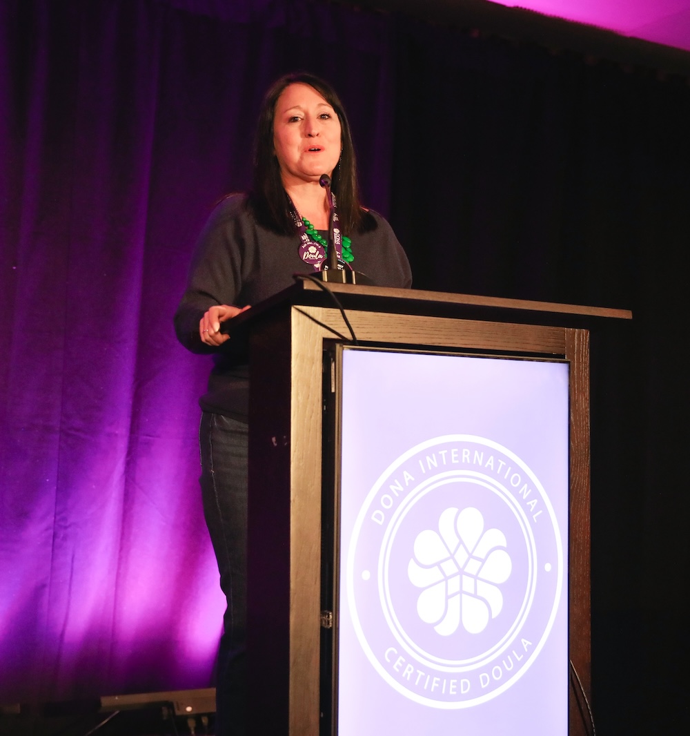 Melissa at the podium on the DONA Summit stage